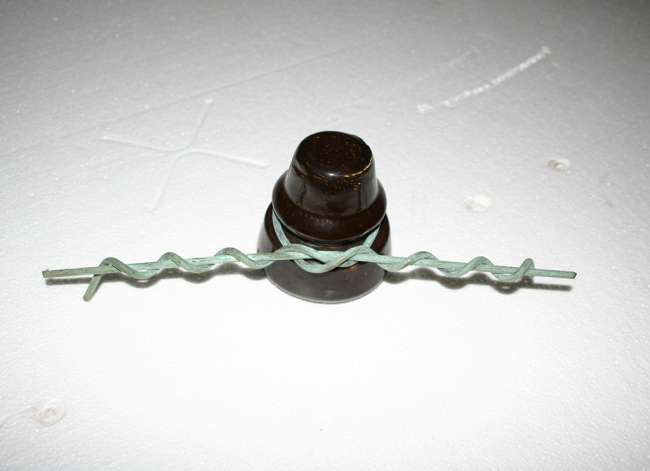 Insulator ties isolate electrical components from metal support structures